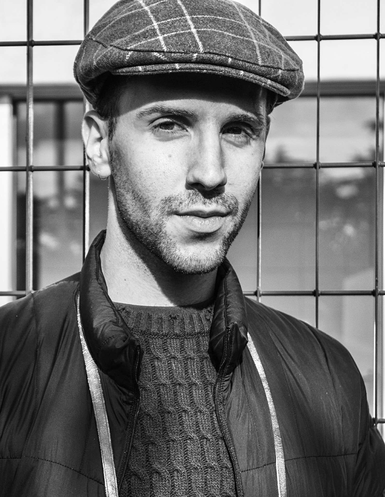Young man in flat cap, black and white street portrait
